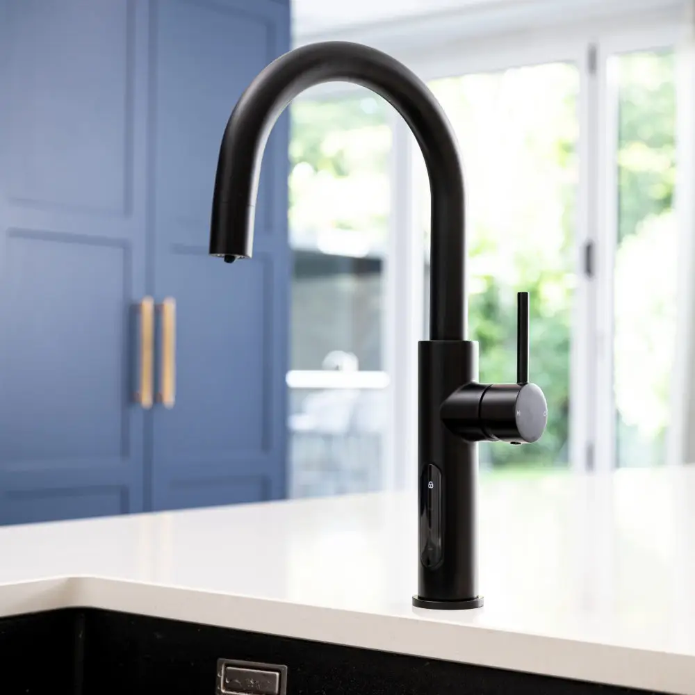 A Black Faucet On A White Countertop