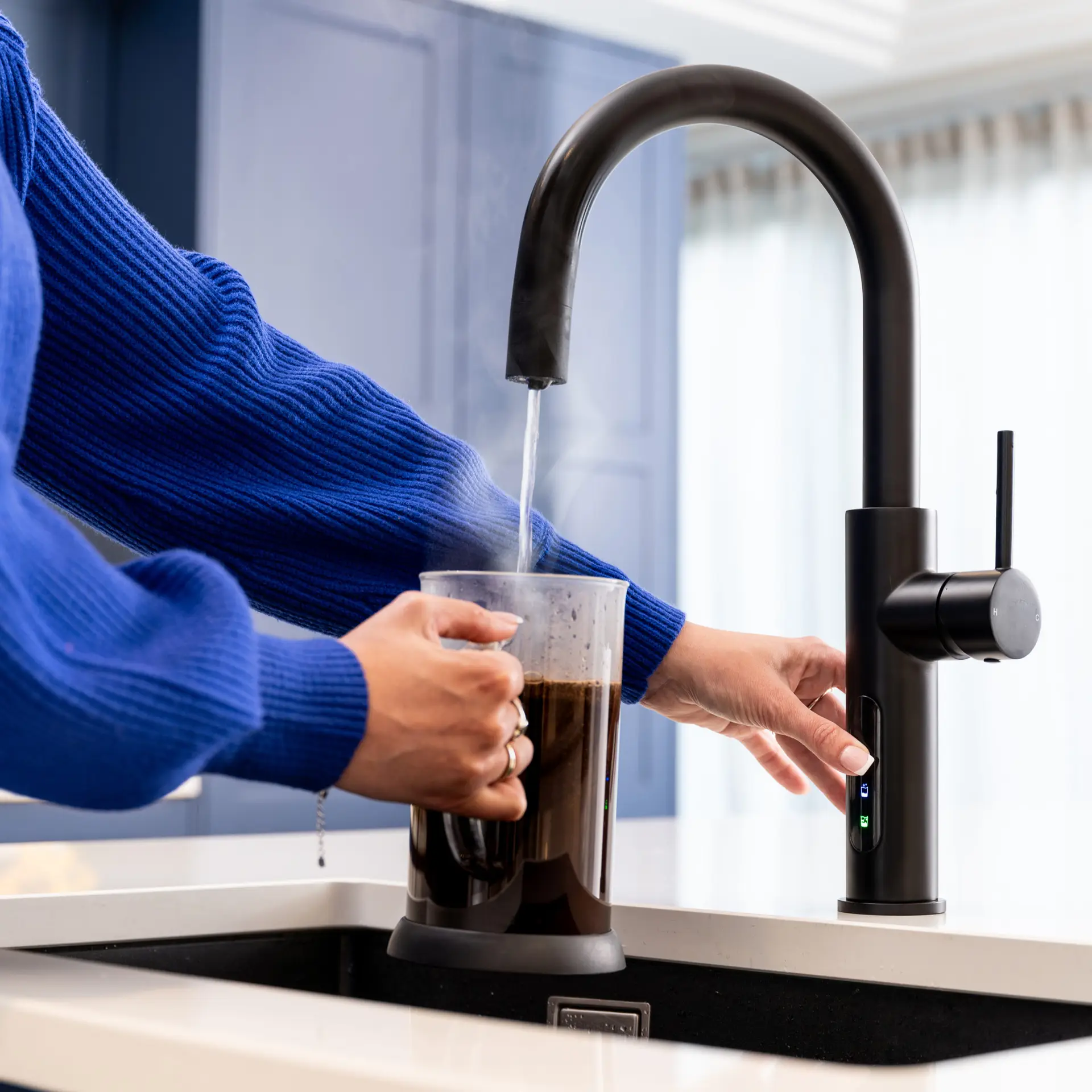 A Person Pouring Boiling Water From A Tap Into A Cafetiere