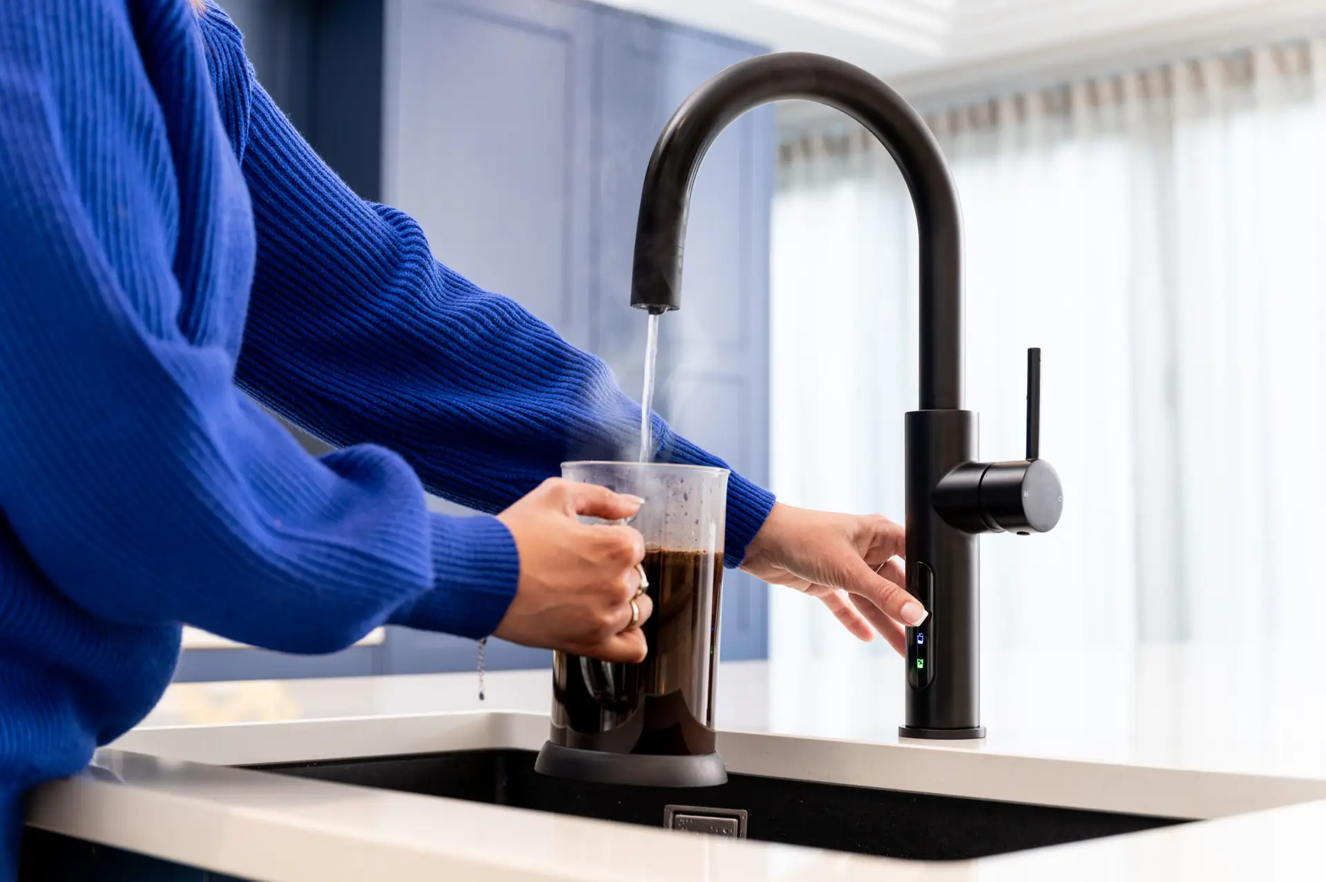 A Person Pouring Boiling Water From A Tap Into A Cafetiere