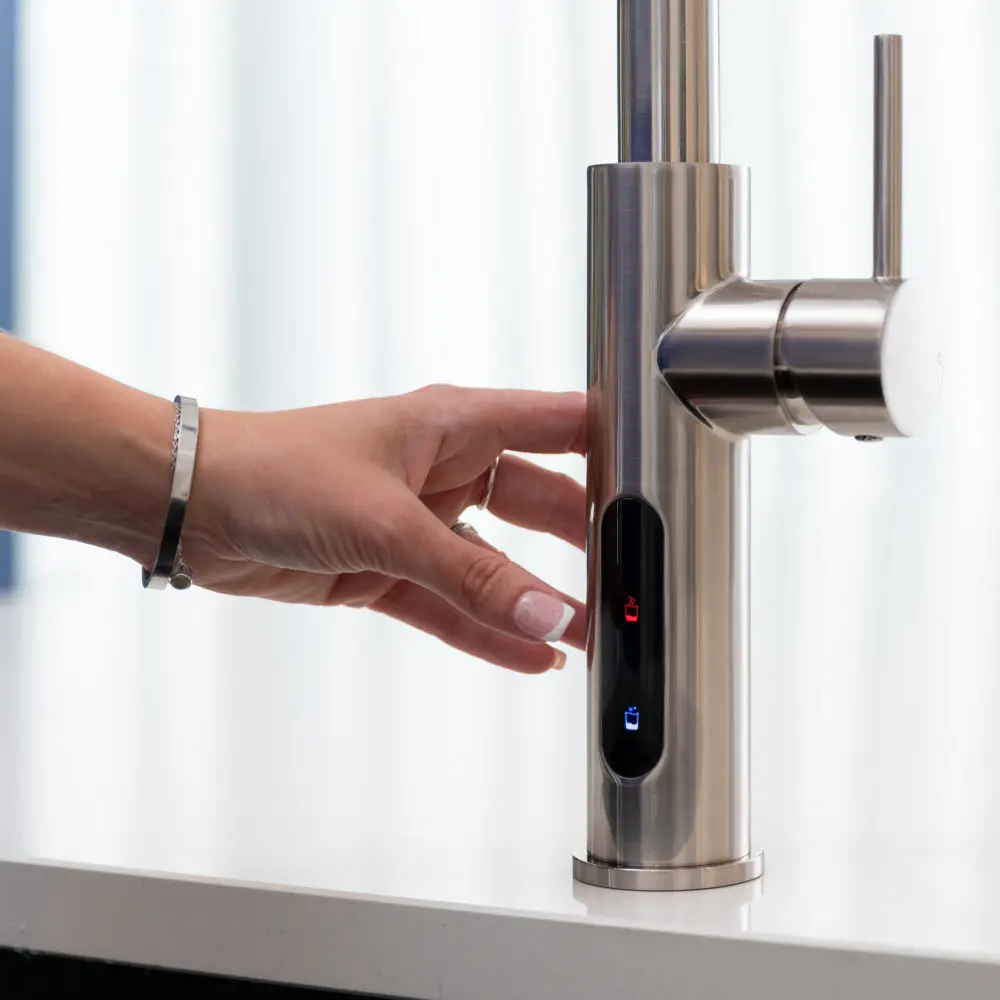 A Finger Pressing A Button On A Black Tap Touch Screen