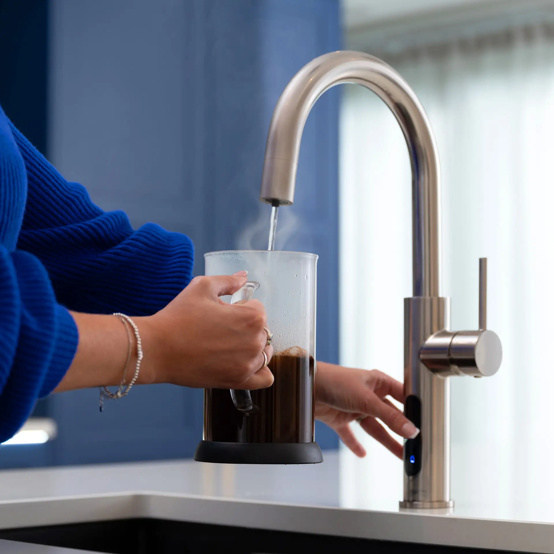 A Person Pouring Boiling Water From A Tap Into A Cafetiere