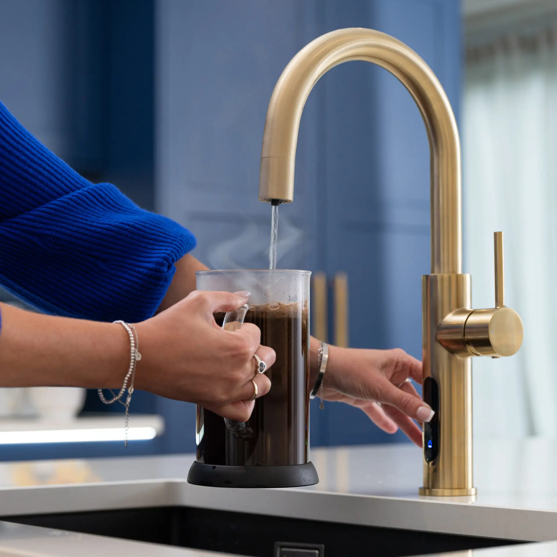 A Person Pouring Boiling Water From A Tap Into A Cafetiere