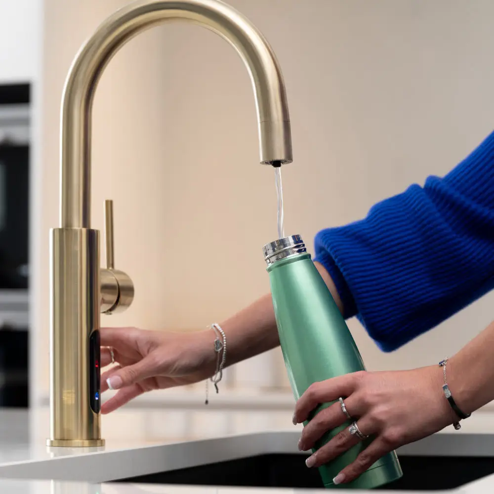 Dispensing Filtered Water Into Water Bottle From Faucet