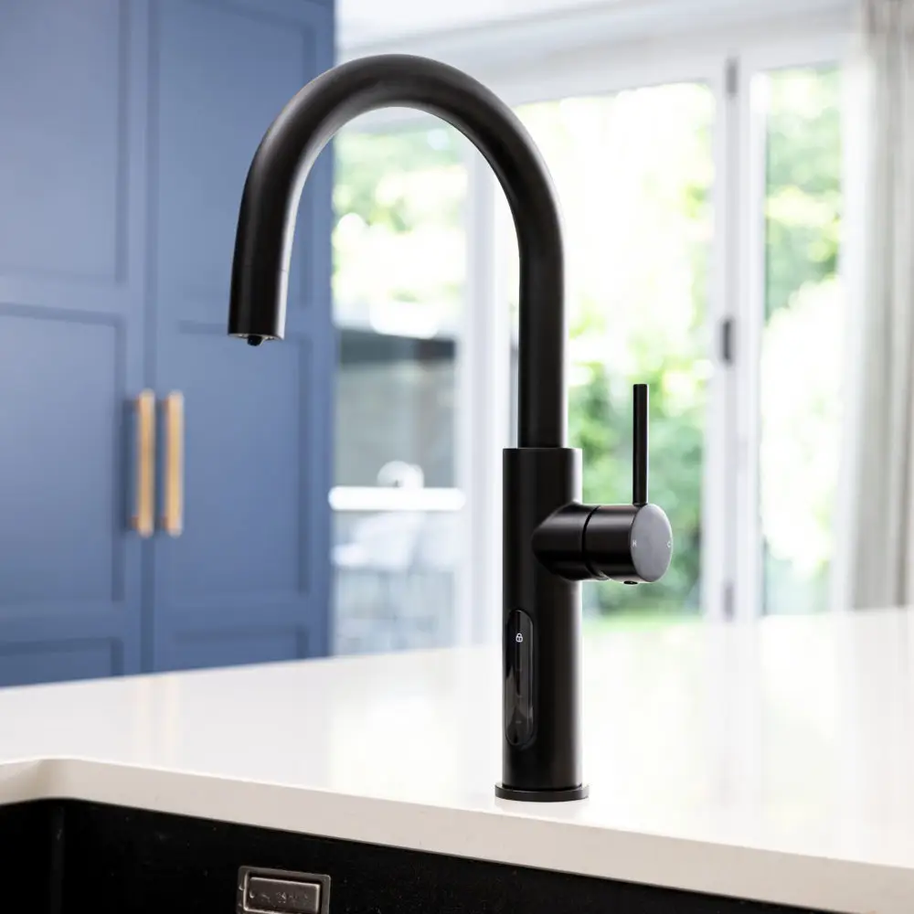 A Black Faucet On A White Countertop